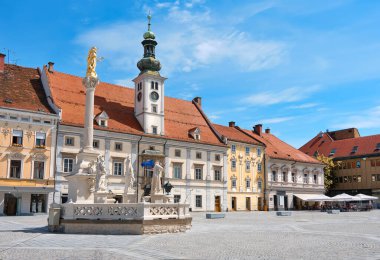 Maribor city center, Slovenia. Town Hall and Plague Monument on the Maribor Main Square. Blue sky, bright daylight, cityscape, tourist destination in Europe. clipart