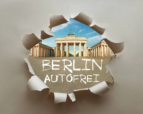 Berlin autofrei, or car free Berlin in German language. Berlin activists push initiative for a car-free Germany. Brandenburg Gate in craft paper hole with text.