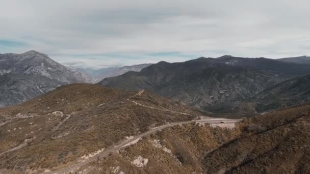 Drone Πυροβολεί Δρόμο Ένα Αυτοκίνητο Ένα Γκρίζο Βουνό Βουνά Στον — Αρχείο Βίντεο
