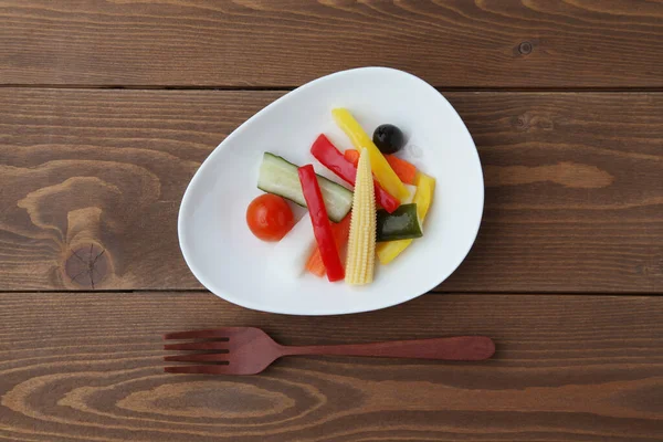 나무 식탁에 따로 놓은 접시 위에서 절인 야채 샐러드 — 스톡 사진
