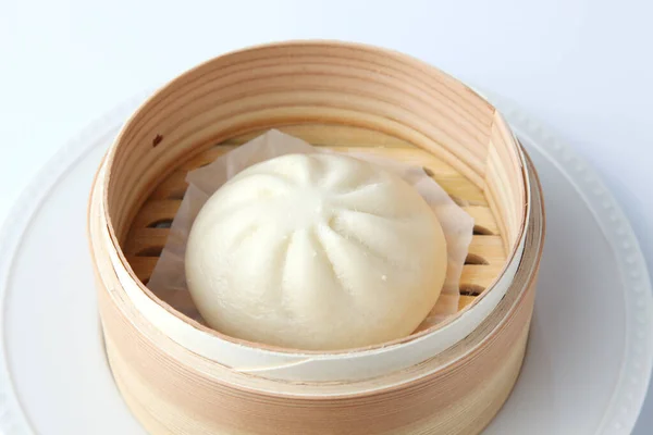 steamed meat bun baozi on white background