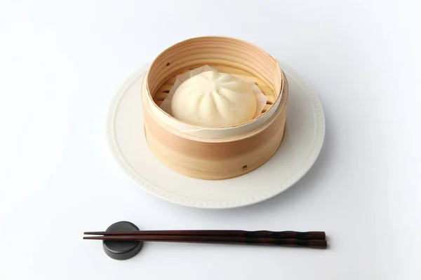 steamed meat bun baozi on white background