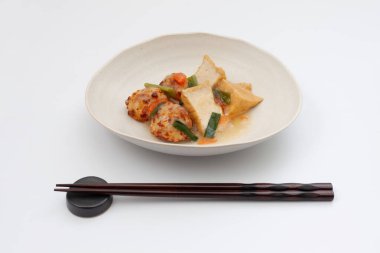 Beyaz arka planda haşlanmış tavuk köftesi ve kızarmış tofu Japon geleneksel mutfağı.