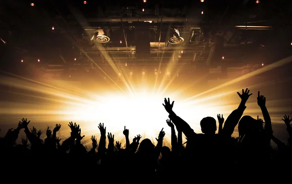 Silhouettes of concert and bright stage lights background Royalty Free Stock Images