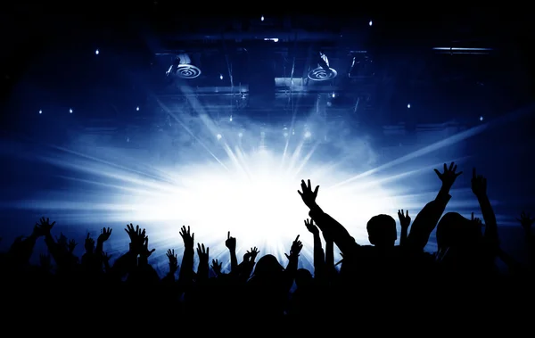 Silhouettes of concert and bright stage lights background Stock Image