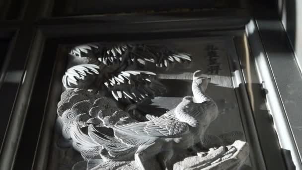 Bas relief art work with morning sun light in Chinese temple. Religious art details — Stock Video