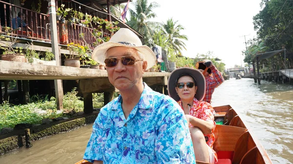 Aziatische senior paar reizen naar thailand cruisen op de boot in de drijvende markt exotische Landmark — Stockfoto