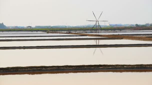 Windmolen en bloem van zeezout in zout pan-farm, zout field met ochtendzon — Stockvideo