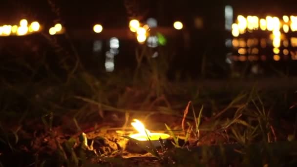 Candle lit at night to pay respect to river goddess at Loi Krathong festival Thailand. — Stock Video