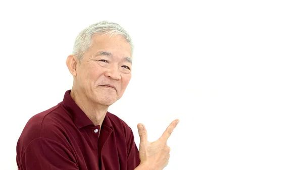 Asian senior pointing smiling on white isolate background — Stock Photo, Image