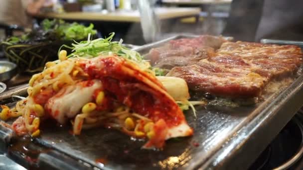 Traditional Korean barbecue and side dishes vegetable food. Grilled on big stone plate — Stock Video