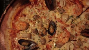 Akşam yemeğinde bir dilim İtalyan deniz mahsulü pizzası seçiyorum.