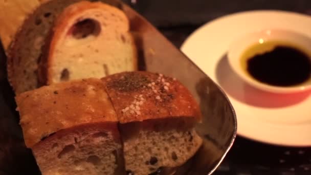 Hands Dipping Fresh Baked Bread Olive Oil Vinegar Italian Restaurant — Stock Video