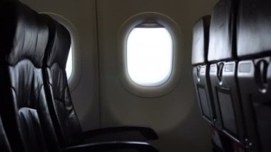 Empty passenger seat rows in plane panning shot airline business problem from pandemic