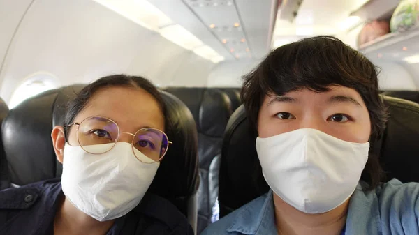 Two Asian Women Travel Mask Plane Flight Selfie — Stock Photo, Image