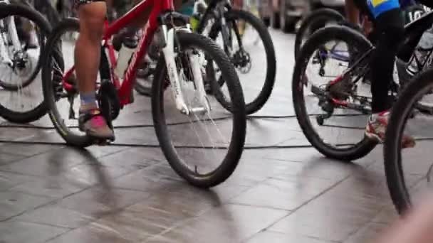 Abstract biking tournament at start line, shot of a group of race cyclists — Stock Video