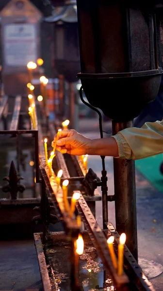 Hand lit candle — Stock Photo, Image