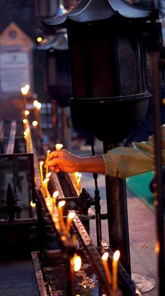 Hand lit candle — Stock Photo, Image