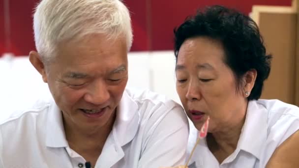 Happy senior asian couple playing and have fun with humour — Stock Video