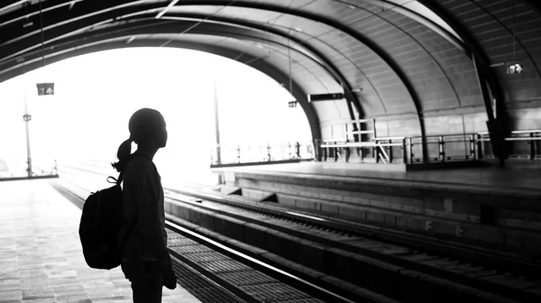 Silhouette for tourist girl backpacker waiting for train at the — Stock Photo, Image