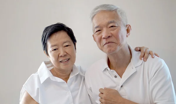 Feliz asiático senior pareja en blanco fondo amor y abrazo — Foto de Stock