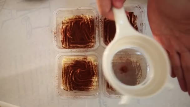 Afstoffen tiramisu taart door poedervorm cacao — Stockvideo