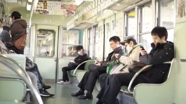 Osaka, Japan -March 2015: Local Japanese people riding the train out to Kyoto in the morning — Stock Video