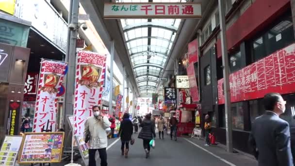 Осака, Джанпан - март 2015: Пешеходы прогуливаются по торговому району Дотонбори в Осаке, Япония — стоковое видео