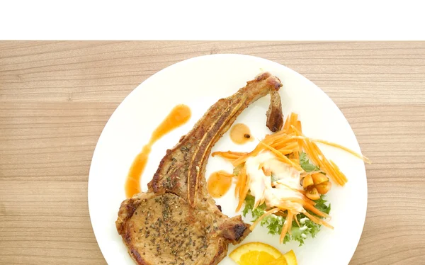 Grilled pork chop steak. Colorful salad and orange sauce — Stock Photo, Image