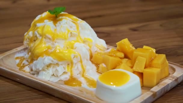 Mango borotvált jég a jégkrém és a puding. Trópusi gyümölcs hideg édes — Stock videók