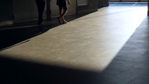 Pedestrian commuters long shadows of people walking at train station in the city — Stock Video