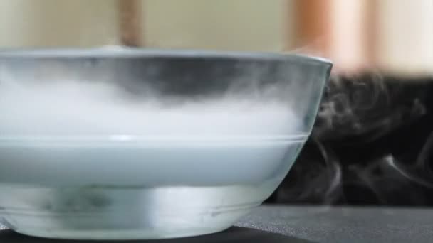 Boiling dry ice in a water with overflowing white smoke — Stock Video