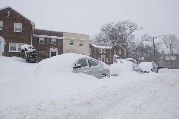 Washington, D.C., USA - January 23, 2016: snow covered cars during a snowstorm