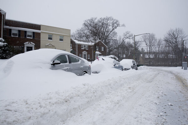 Washington, D.C., USA - January 23, 2016: snow covered cars during a snowstorm