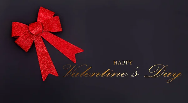 Valentines Day gift with red bow Isolated on black Background. Red bow. Valentines day card concept.