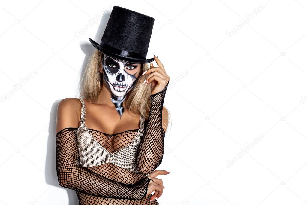 Female model in Halloween silence. Sexy woman in  skull make up on white background. Halloween makeup concept.