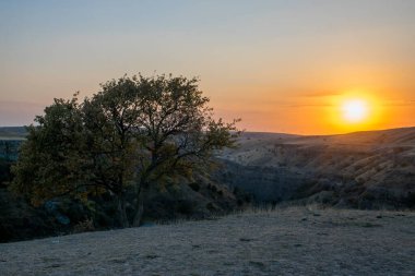 Sonbahar mevsiminde dağların üzerinden gün batımının manzarası