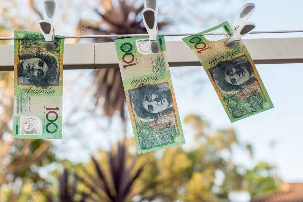 Australian 100 dollar bank notes hanging out to dry on a clothes line.