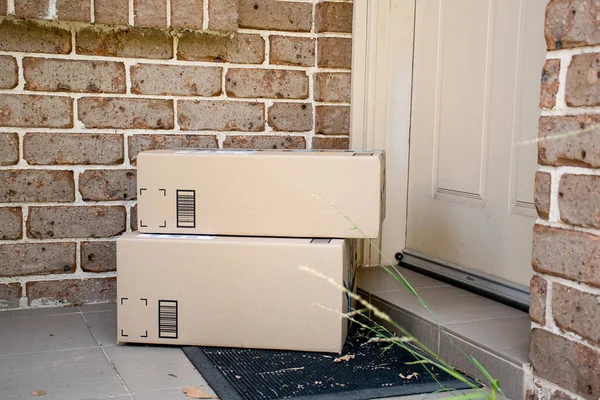 Parcel boxes delivered to a front door of residential building. Online shopping and delivery