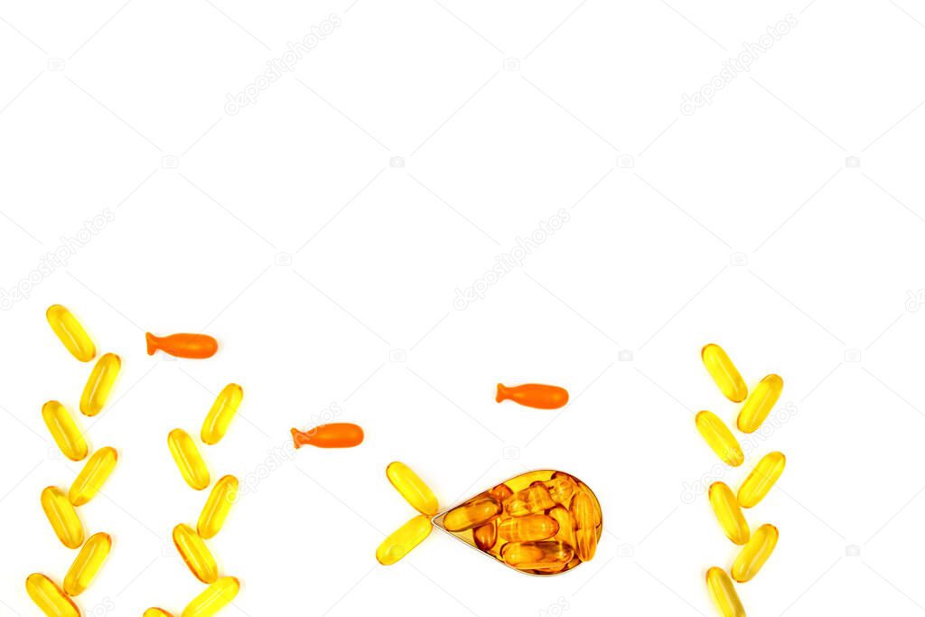 Omega-3 fish oil capsules in a shape of a fish on white background. Vitamins and supplements