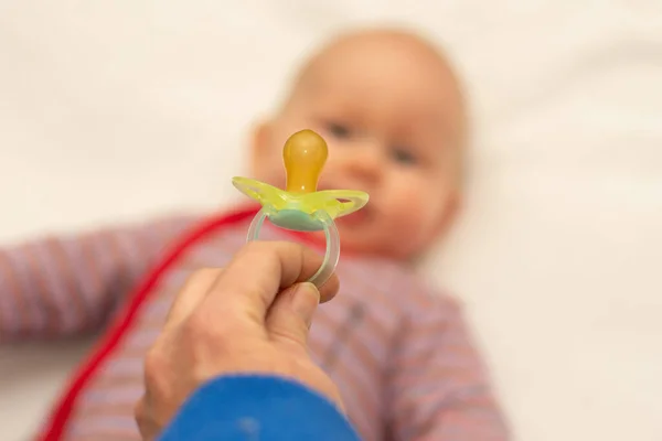 Adult Hand Showing Dummy Pacifier Small Little Defocused Baby Giving — Stock Photo, Image