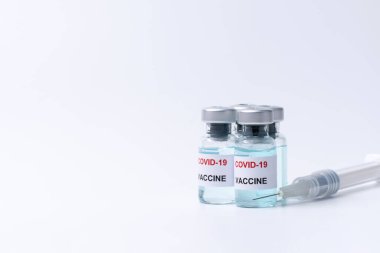 Covid-19, grip, Coronavirus sıvı aşı şişesi ve beyaz arka planda izole edilmiş enjeksiyon için hazırlanan şırınga. Covid-19 virüs kavramına karşı aşı.