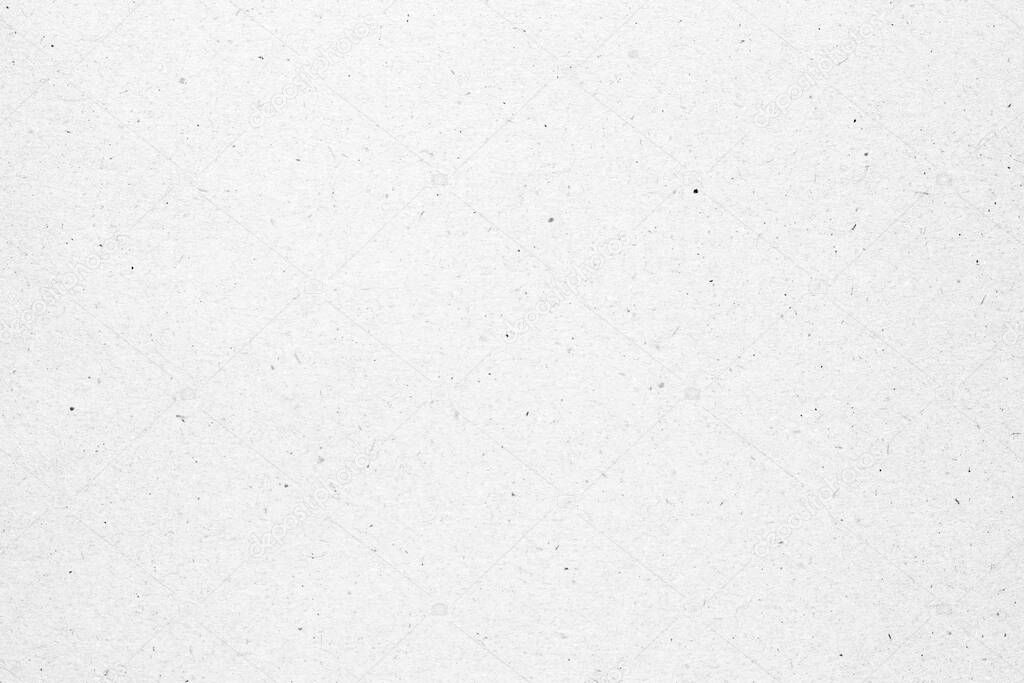 White paper or cardboard texture with black spot background.