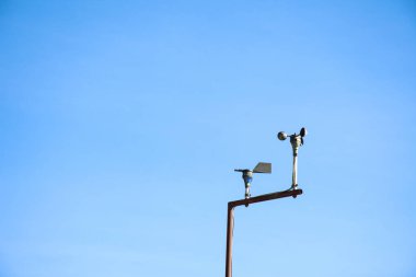 Meteorolojik hava istasyonunda mavi gökyüzü arka planına sahip bir amnemometre.