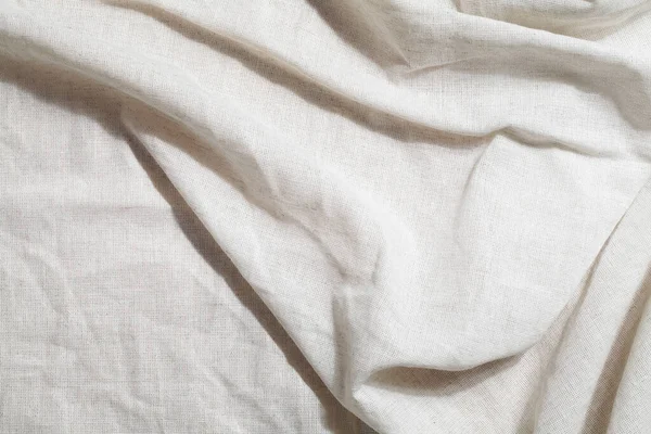 crumpled linen textile with shadow. Organic Eco material. Minimalistic cozy light background. kinfolk design