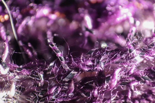Close up of purple fabric fibers of a scarf