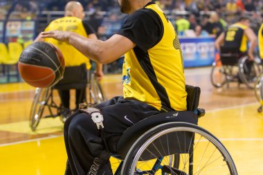 unidentified people play a friendly game of wheelchair basketbal clipart