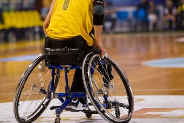 unidentified people play a friendly game of wheelchair basketbal clipart