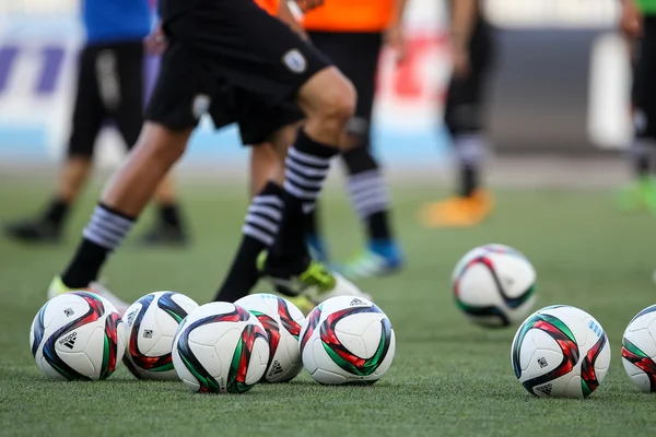 Soccer ball and feet of players — Stock Photo, Image