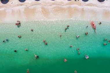 Porto Vathy, Marble Beach, Thassos, Greece- July 19, 2021: aerial view of the Porto Vathy beach of relaxed people swimming on a clear and transparent sea clipart